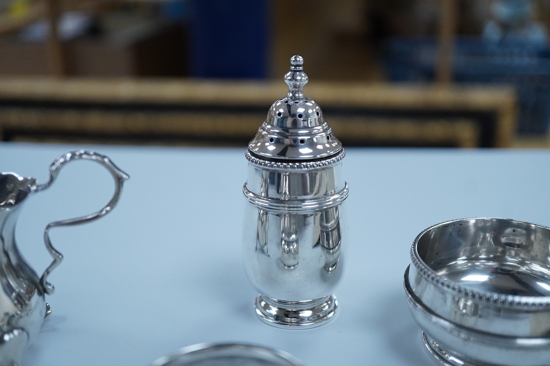 Small silver including a three piece cruet set, by George Howson, Sheffield, 1924/5/6, a napkin ring, a cream jug and a set of six 830s coffee spoons.